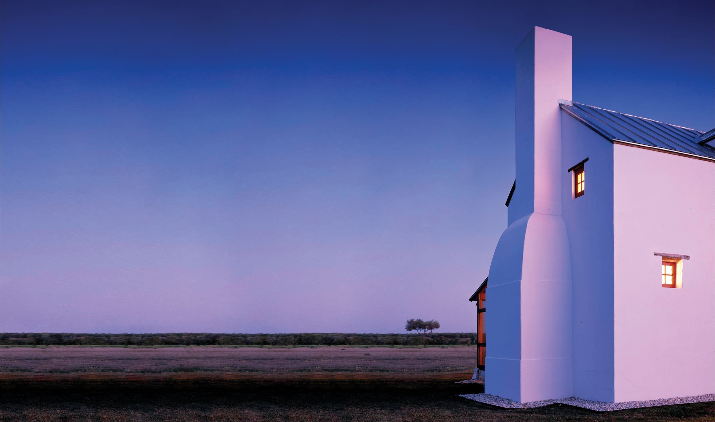 White farmhouse at sunset