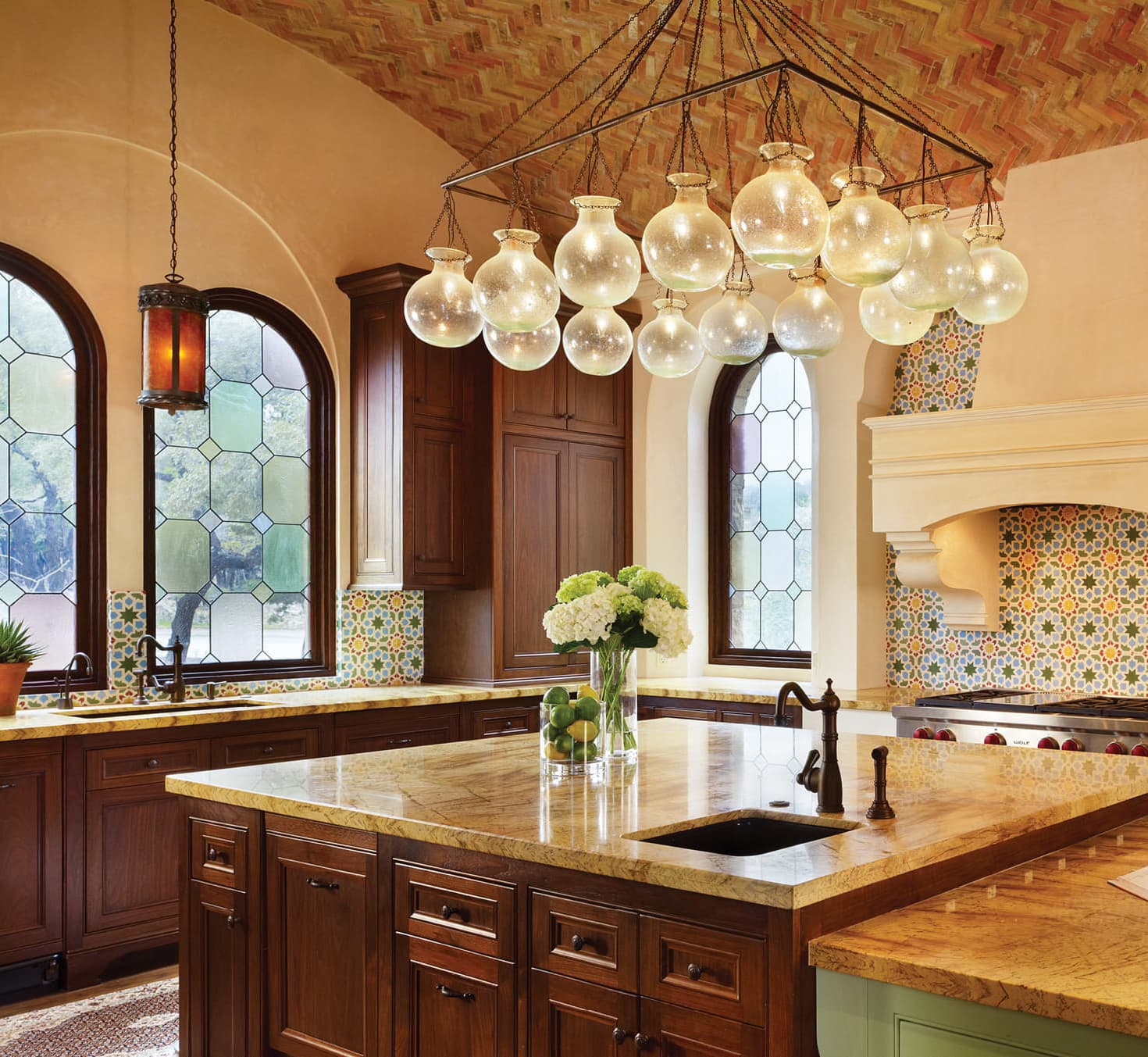 Kitchen with marble counters and glass bulb chandelier
