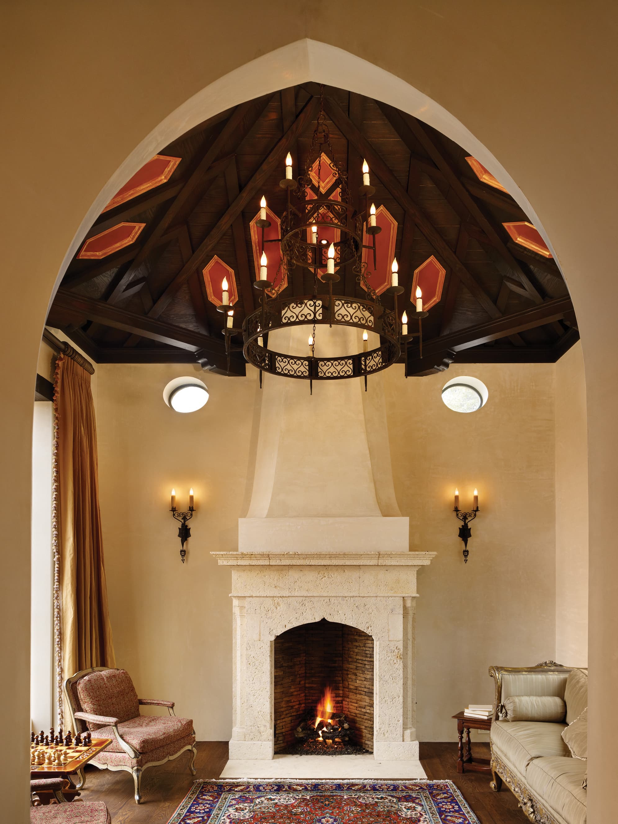 Sitting area with iron chandelier and fireplace